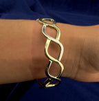 Pobjoy 9ct yellow and white gold hinged openwork bangle, 18.17 g, Sheffield hallmarked