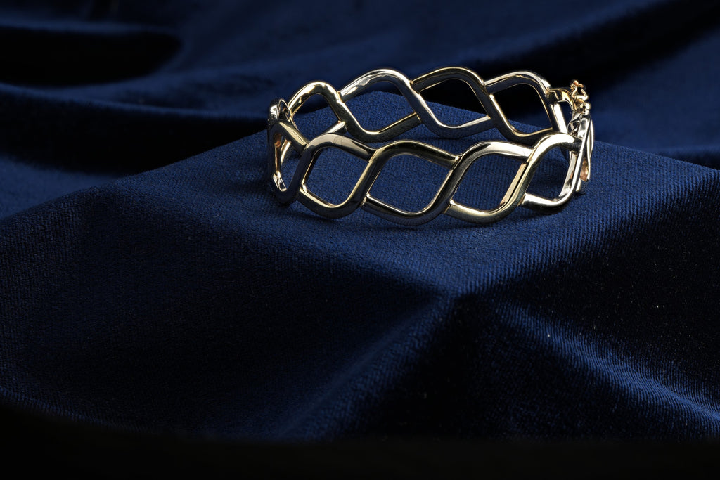 Pobjoy 9ct yellow and white gold hinged openwork bangle, 18.17 g, Sheffield hallmarked