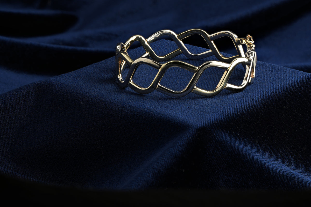 Pobjoy 9ct yellow and white gold hinged openwork bangle, 18.17 g, Sheffield hallmarked